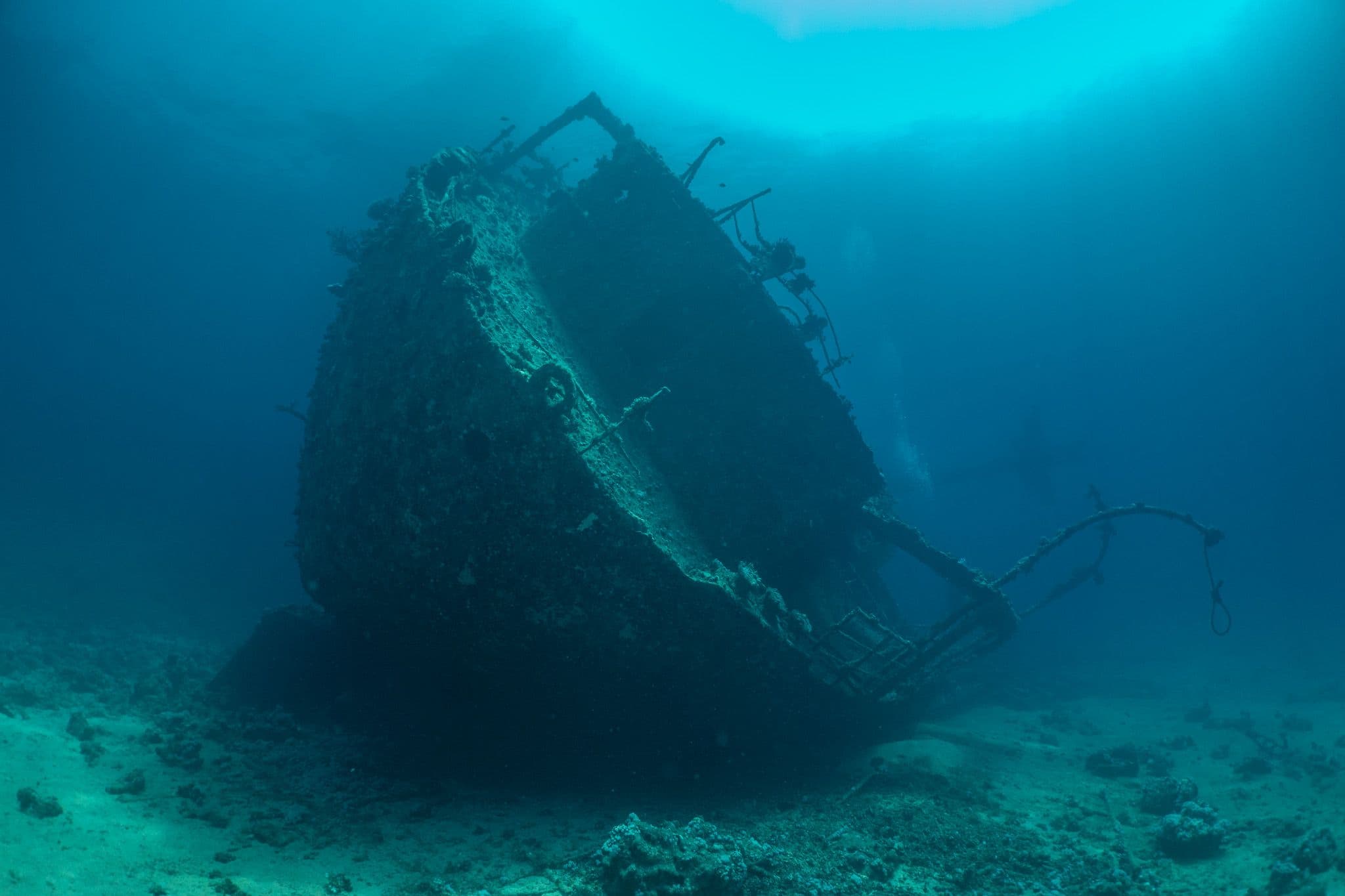 Diver descending beside a Red Sea wreck during Advanced Open Water training